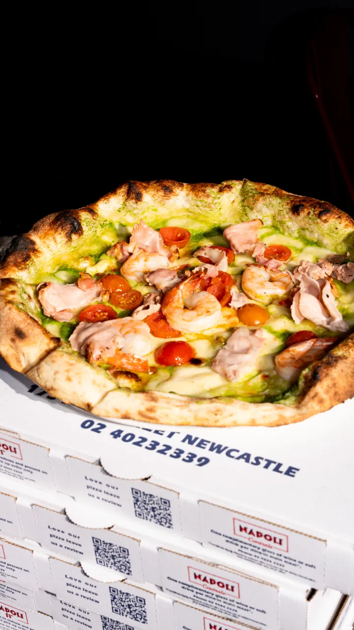 Wood-fired prawn and pesto pizza on Napoli Centrale boxes