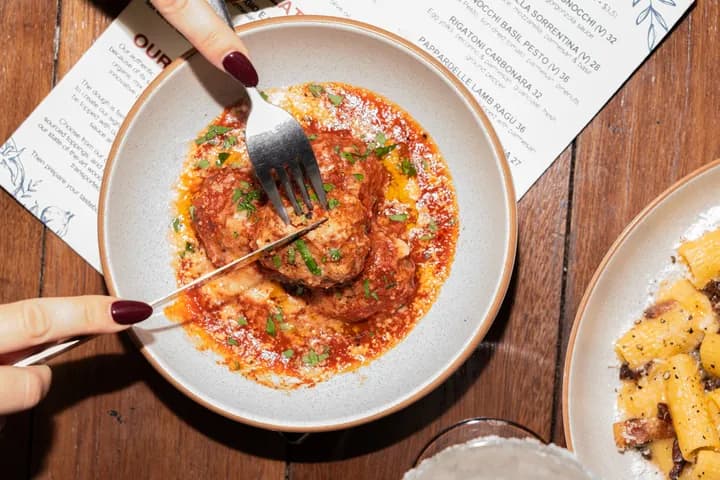 A meatball in sauce in a bowl
