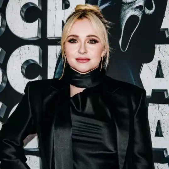 A woman in a black top looking at the camera