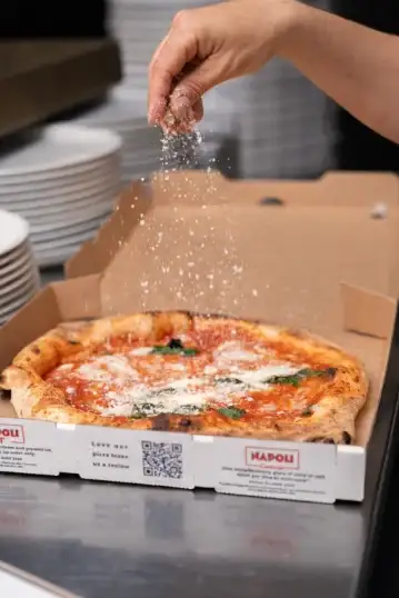 A wood-fired pizza on a table