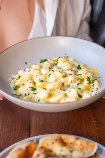 A bowl of pasta with fresh herbs